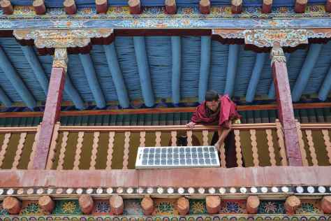 A monk positions a solar PV panel at the remote Hemis Monastery in Ladakh, India. Debdatta Chakraborty